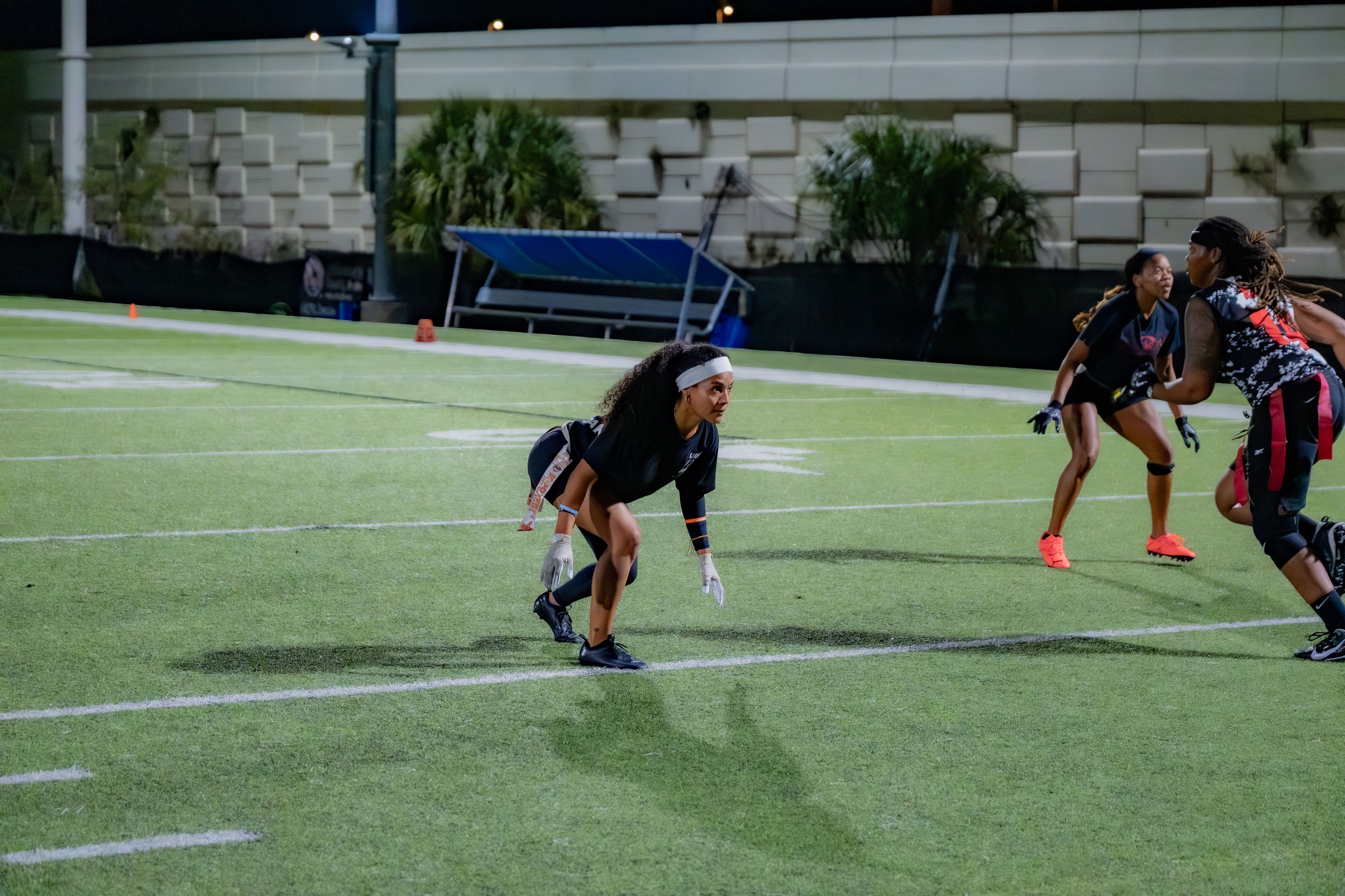 Flag football players competing during a night game